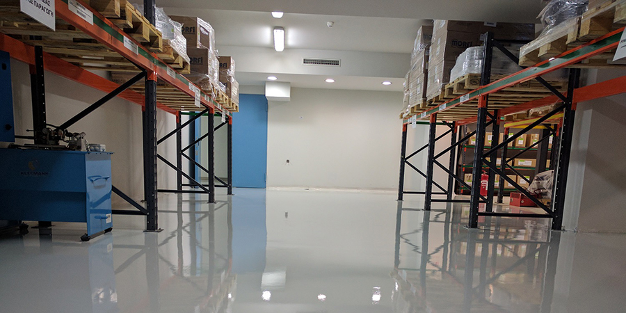 This image shows a warehouse with a white epoxy floor.