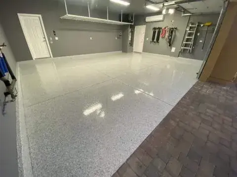 Metallic-Epoxy-Garage-Floor-480x360-1 This image shows a garage.